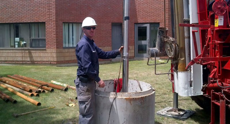 photo of jamie mackinnon installing a well water pump